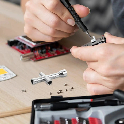 Pocket Sized Cross Socket Wrench For RC Models And Robot Repairs Tiny Nut Tool on a desk with small hex screws