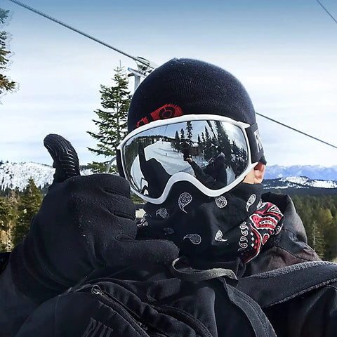 Skier wearing OTG Ski Goggles With Double Lens Anti Fog Ventilation And UV Protection For All in snowy mountain setting