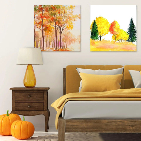 Bedroom with autumn-themed paintings, wooden side table, orange lamp, and pumpkins