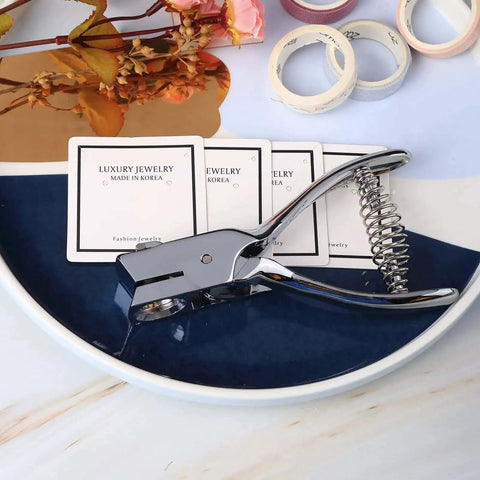 Go-To All Metal Single Hole Puncher With Lever on desk, punches up to eight A4 sheets, oval hole 0.59x0.16 inch, ideal for office use.
