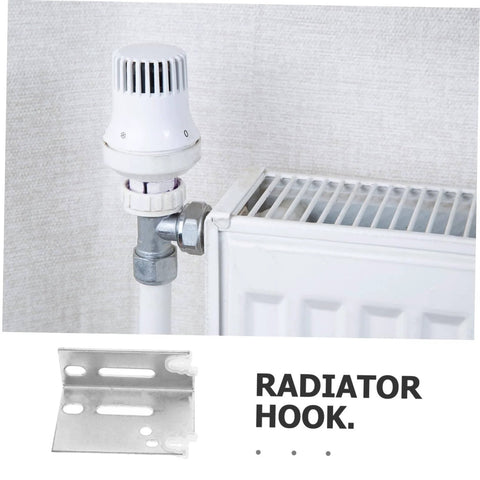 Steel radiator hook next to radiator valve seen in a domestic setting, showing installation configuration for holding pipes.