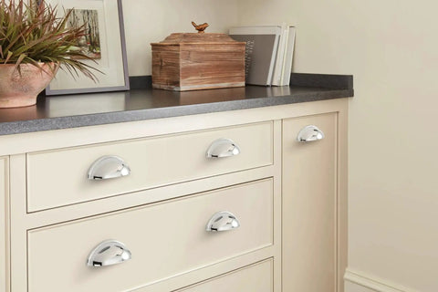 Ravino Polished Chrome Cabinet Cup Pull 3 Inch Center To Center Drawer Handle installed on cream cabinet drawers.