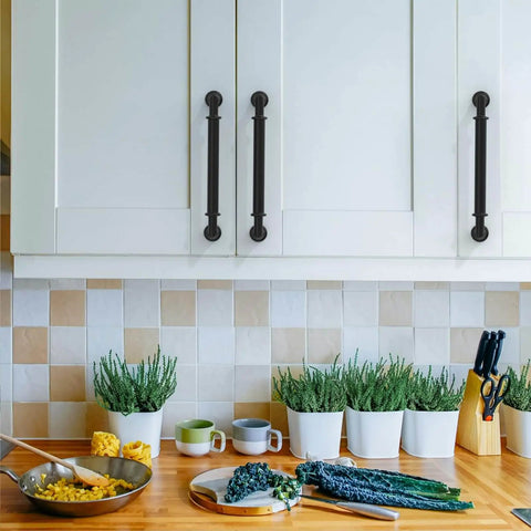 Matte Black 5 Inch Cabinet Handles Set 10 Pack Heavy Duty Solid Metal Kitchen Cabinet Pulls For Cupboards And Drawers Rustproof Anti Corrosion Non Toxic Easy To Clean And Install Diy Friendly Asidrama installed on white cabinets in a kitchen setting with plants and utensils on the counter