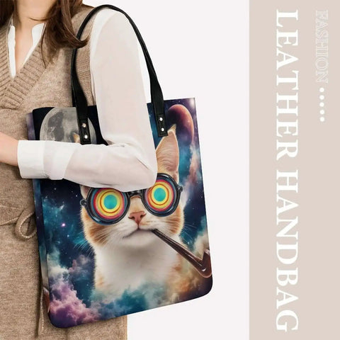 Colorful cat print leather tote bag held by model, vibrant design with black straps.