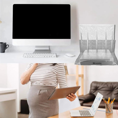 Faraday box WiFi router cover in silver mesh EMF cage on desk with an iMac, keyboard, mouse; person holding a tablet.