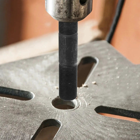 Close-up of Heavy Duty Hydraulic Punch Driver Kit with pull rod lock cap creating hole in metal sheet for electrical work.