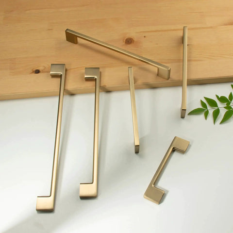 Classic 10 Pack Cabinet Pull Handles for Kitchen and Bedroom Cabinets in Champagne Bronze Finish, displayed on a table, 5 Inch Center To Center Screw Spacing, Solid Zinc Alloy Construction, Easy To Install.