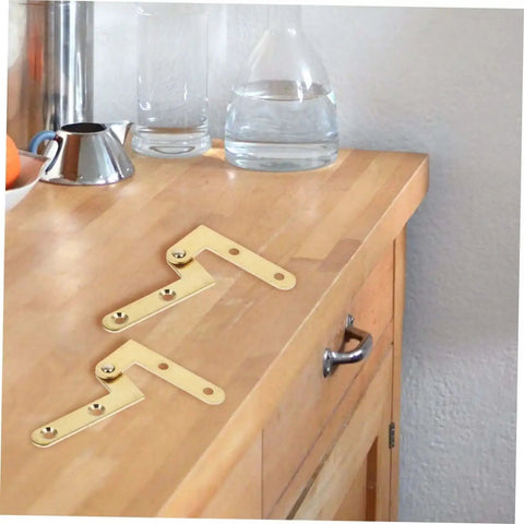 Rotatable Copper Pivot Door Hinges Set for Hidden Doors and Cabinets on wooden countertop, showing durable copper construction.