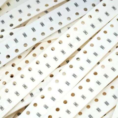 SMD resistor strips on white perforated carrier tape with 1206 resistors for PCB assembly