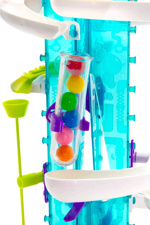 Thames and Kosmos Gumball Machine Maker toy, front view with turquoise translucent frame, clear gumball tube, and multicolor balls.