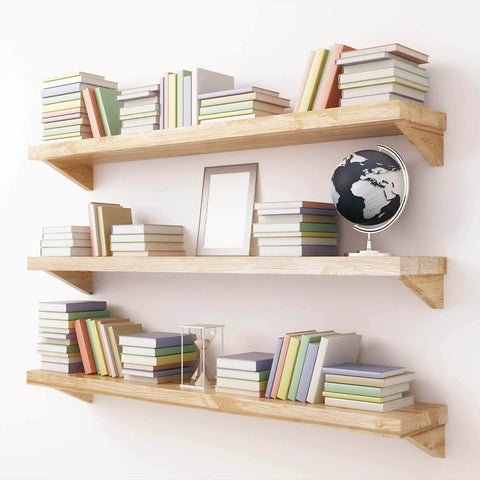 Floating shelves with books and decor items against a white wall.