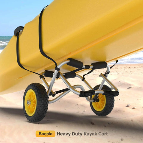 Go-To Universal Kayak Carrier Trolley showing anodized aluminum frame, solid airless tires, and kayak support straps on beach