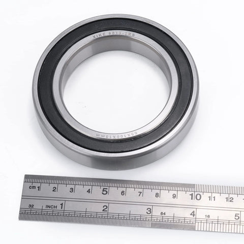 XiKe 6013-2RS double rubber seal bearing, 65x100x18 mm, steel with black rubber seal, shown next to a ruler