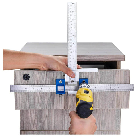 Cabinet Hardware Jig For Handles And Knobs in use, aligning drill guide sleeve with a drawer using an electric drill.