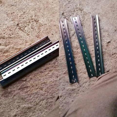 Four Pcs DIN Rail Slotted Design Steel Rail Mounts, 200Mm Long, 35Mm Wide, 7.5Mm High, Galvanized, laid on concrete.