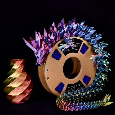 Tri Color Coextruded Silk PLA Filament For 3D Printing 1.75mm 1kg Rainbow Red Yellow Blue With Silk Finish next to printed vase and sculpture