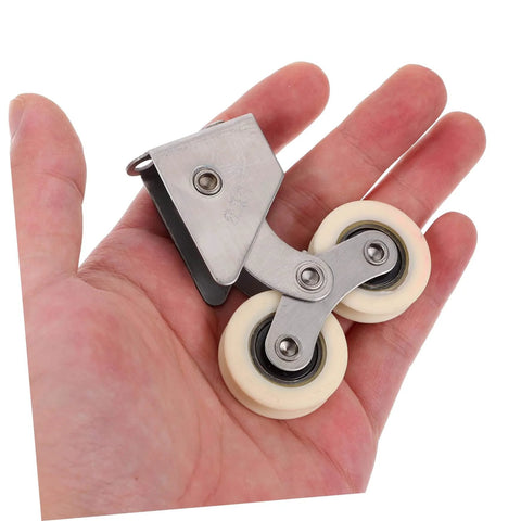 Person holding heavy duty sliding door rollers kit, 2 pack aluminum alloy wheels with stainless steel track.