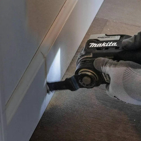 Image of 18V LXT Sub-Compact Brushless Cordless Multi-Tool With Variable Speed Control 10,000 to 20,000 OPM in use against baseboard.