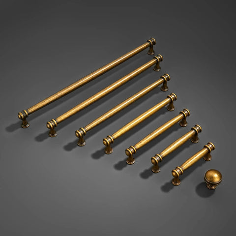 Variety of antique brass cabinet pulls in different sizes, showcasing heavy duty zinc alloy handles with a flat brushed brass finish.
