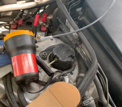 Portable 12V 60W Oil Extractor Pump For Fluid Changes in use for a car engine oil transfer, electric, compact design with battery clips.
