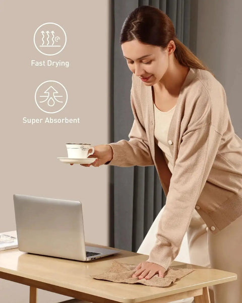 Person using Tear-Away Microfiber Cleaning Cloth Roll 12-Inch Reusable 75 Pack to clean a table near a laptop