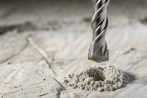Close-up of Go To Heavy Duty 4 Piece 12 Inch SDS Plus Drill Bit Set With Carbide Tipped Masonry Bits drilling into concrete