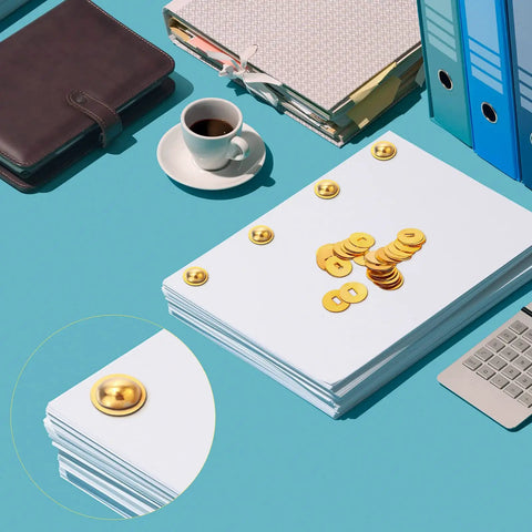 Gold Brass Washers And Paper Brads 500 Piece Set For Paper Crafts Scrapbooking And DIY Projects 15mm Outer Diameter 3mm Inner Diameter Metal Fasteners With Storage Box Included on a desk with folders and coffee cup