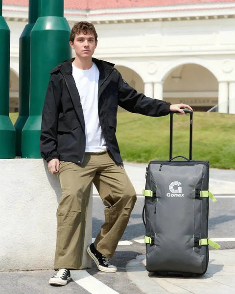 Person with Rugged Rolling Duffle Bag With Wheels For Travelers, Water Repellent 30 Inch Nylon Large Wheeled Travel Duffle Luggage.