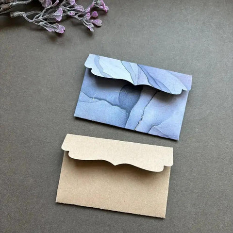 Must Have Envelope Die Set For Scrapbooking And Card Making with layered envelopes on dark background, showcasing DIY crafting potential.