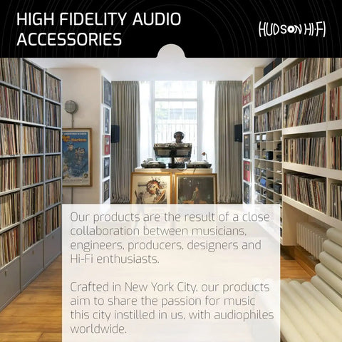 Room with vinyl records on shelves, turntable setup, and high fidelity audio accessories display in store setting.