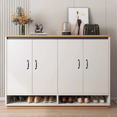 Front view of white cabinet with matte black aluminum alloy handles, showcasing a stylish decor with flower vase and art print