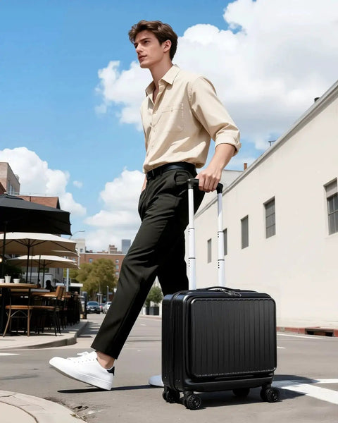 Man walking outside pulling Compact 16 Inch Carry On Luggage With Front Laptop Pocket And TSA Lock With Wheels Airline Approved Hard Shell Suitcase For Travel Front Access Compartment Fits A 15.6 Inch Laptop Lightweight Durable Black Lekebobor.