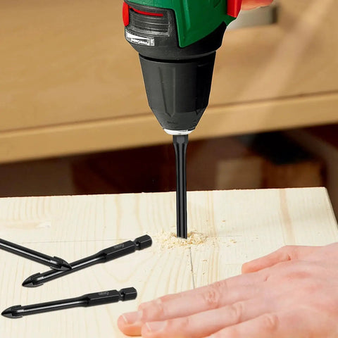 Image of a drill using a Twenty Piece One Quarter Inch Tile Drill Bit Set With Six Millimeter Masonry Bits Alloy Oxy Nitrided For Long Life And Sharp Cutting Hex Shank Great For Quick Clean Holes In Tile Glass Mirror Ceramic Wood Brick And Concrete on a wooden surface. Additional bits are visible beside the drill.