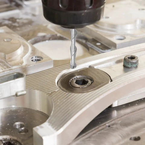 Close-up of Top Notch Ball Nose End Mills Set For CNC Router Bits By Uxcell engraving metallic surface.