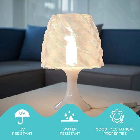 Table lamp with a twisted shade made from transparent 3D printed polycarbonate, showcasing UV and water resistance benefits.