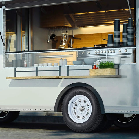 Food truck with open serving window, stainless steel kitchen, and trailer tire and wheel set with ST175/80D13 tire on 13 inch rims