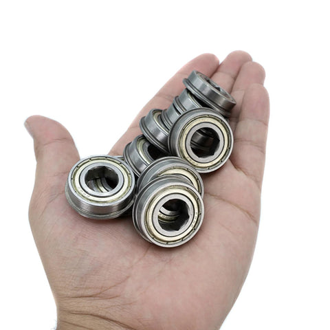 Steel flanged ball bearings with hex bore, 1/2 in hex ID, 1-1/8 in OD, 5/16 in wide; 10-pack held in palm.