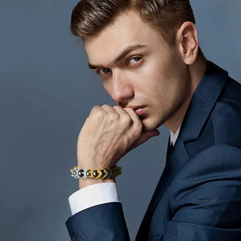 Man wearing a bracelet made with 200 Piece Mini Crown Charms For Jewelry Making Colorful Gold And Silver Mixed Metals Large Hole Spacer Beads.