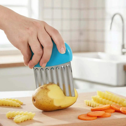 Hand using Two Pack Crinkle Cutter Set For Potatoes And Vegetables Stainless Steel Waffle Fry Cutters For Making Waffle Fries Carrot Chips And More Durable Kitchen Knife With Safe PP Handle In Green And Blue on potato and carrots