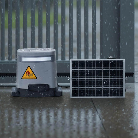 Solar Sliding Gate Opener System With 280W Motor That Powers Gates Up To 65.6 Ft And 1799 Lbs, Includes Two Remote Controls And Solar Panel For Easy, No Fuss Driveway Gate Access, shown in outdoor setting with motor and panel visible during rain.