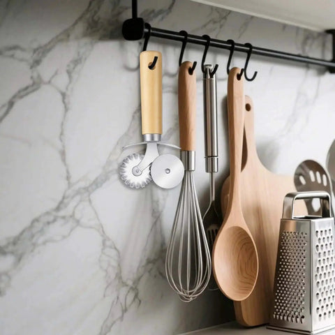 Dual Wheel Pasta Cutter And Ravioli Crimper With Crinkle Wheel And Wooden Handle For Dumplings Dough Noodles Pizza Cookies And Pastry Making The Real Deal For Home Kitchen Use Sibba hanging on a kitchen rack with utensils.