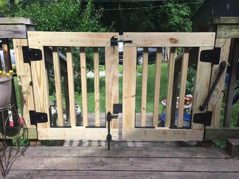 Wooden gate with Heavy Duty Black Gate Hinges 3.5 Inch With Screws Pack Of 6 for wood fences and barn doors outdoor setup.