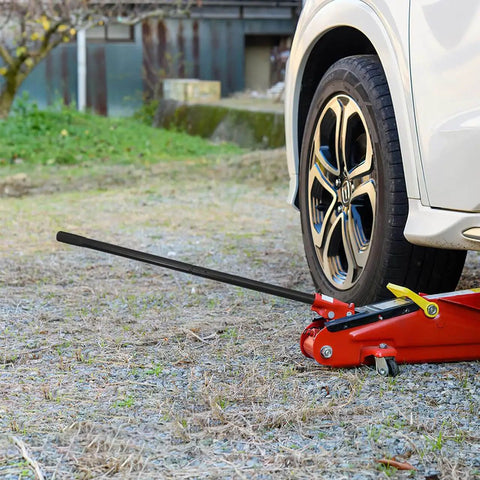 3 Ton Jack Handle Replacement For Horizontal Hydraulic Jack lifting a car wheel, heavy duty carbon steel build, non-slip grip.