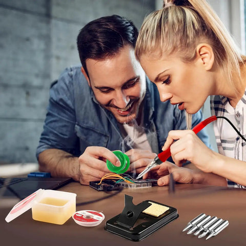 Pro Grade 100W Digital Soldering Iron Kit With Ceramic Heater And LED Display in use, showing iron with accessories like tips and flux.
