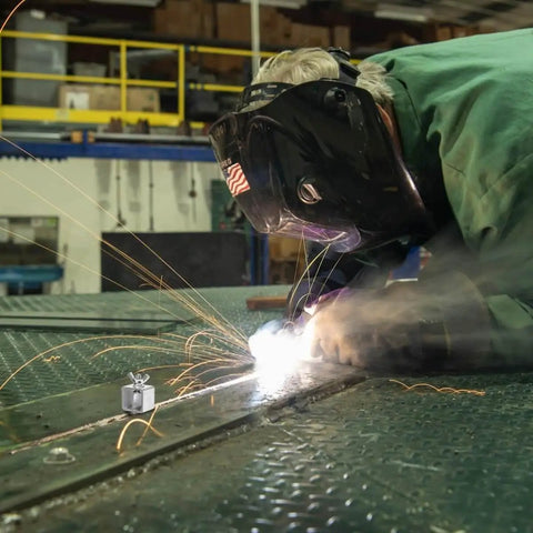 Welder using 24 Pack Butt Welding Clamps Pro Grade for Edge to Edge Welding, sparks flying during auto body panel repair.