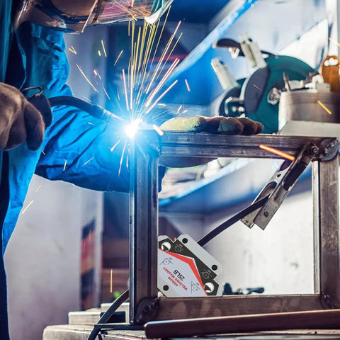 Person welding metal frame using Heavy Duty 25 Pound Welding Magnets Four Pack With Arrow Shaped Hold For Precise Angles In Metal Fabrication