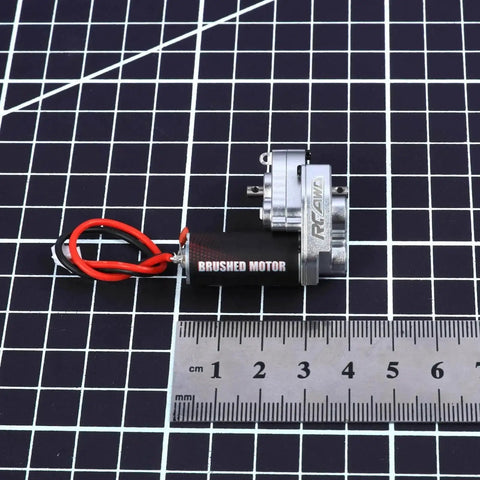 Upgraded 55T Carbon Brush 050 Motor with aluminum gear case for Axial SCX24 models, shown with ruler for scale.