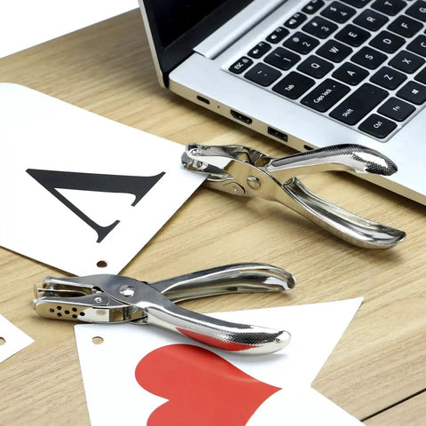 24 Pack One Quarter Inch Single Hole Puncher Set With 5 Sheet Capacity shown on a desk with greeting cards and laptop, metal construction.