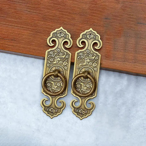 Two Pack Vintage Style Embossed Brass Drawer Pulls for Wardrobe Bookcase and Double Doors in antique bronze finish on wood surface