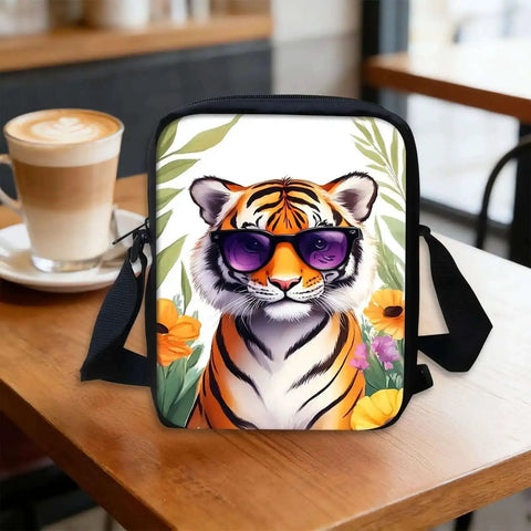 Hands Free Crossbody Sling Bag For Women And Men Ultra Lightweight Everyday Chest Pack With Adjustable Strap And Zipper Small Messenger Style Bag For Travel Work And Daily Use Tiger Print With Sunglasses displayed on a table